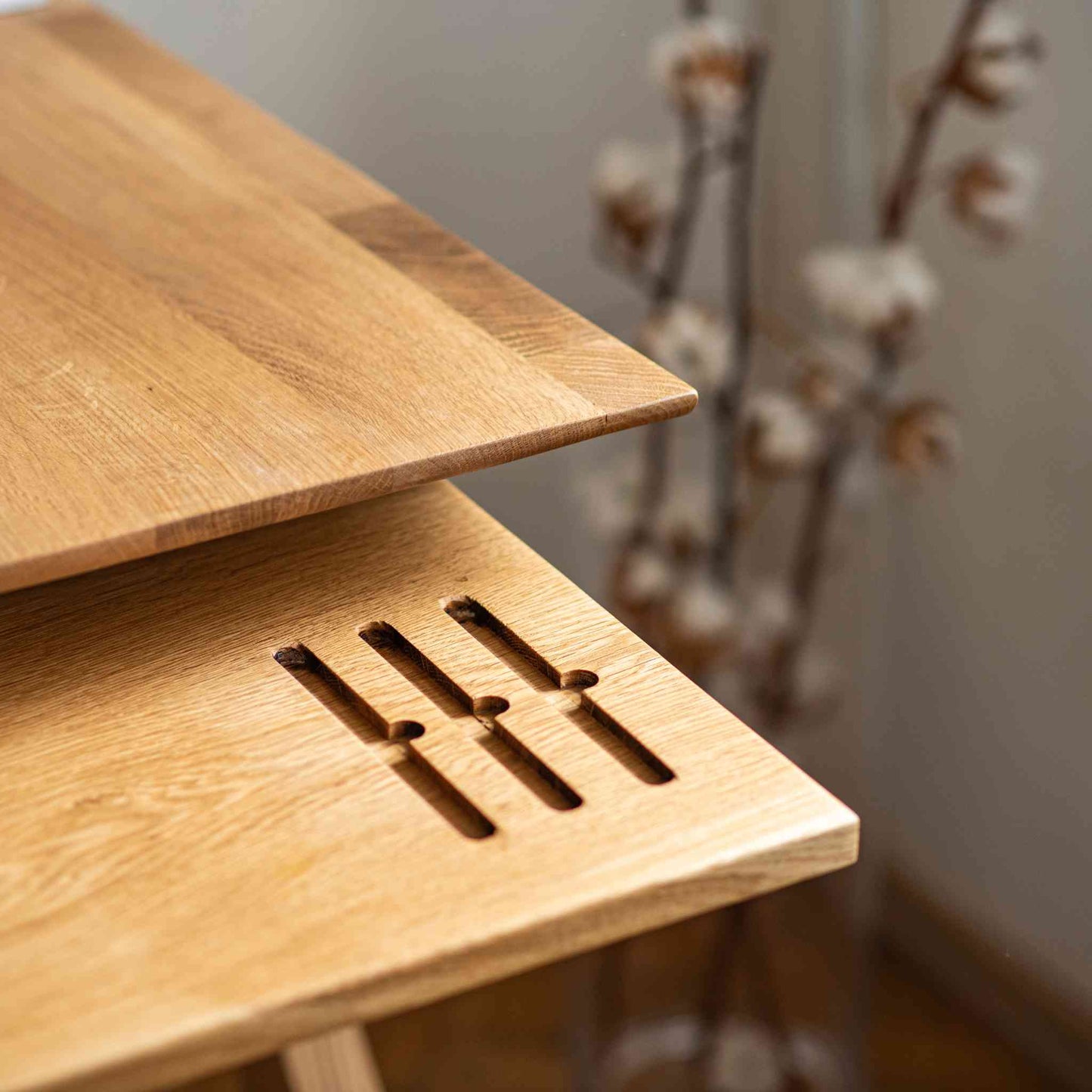 Tray detail of the Cervin Desk with a unique hourglass shape in solid oak wood