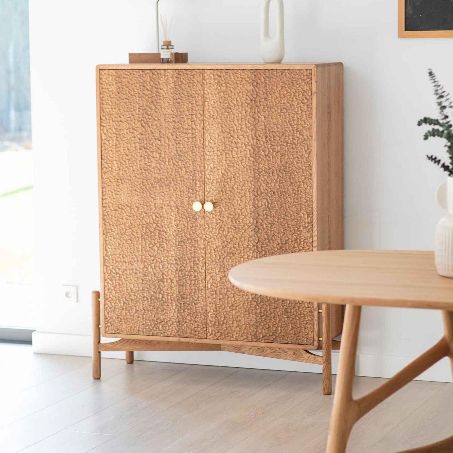 Interior arrangement with the ÉTAUDORÉ Areuse highboard and Dom table, made to order from solid oak wood