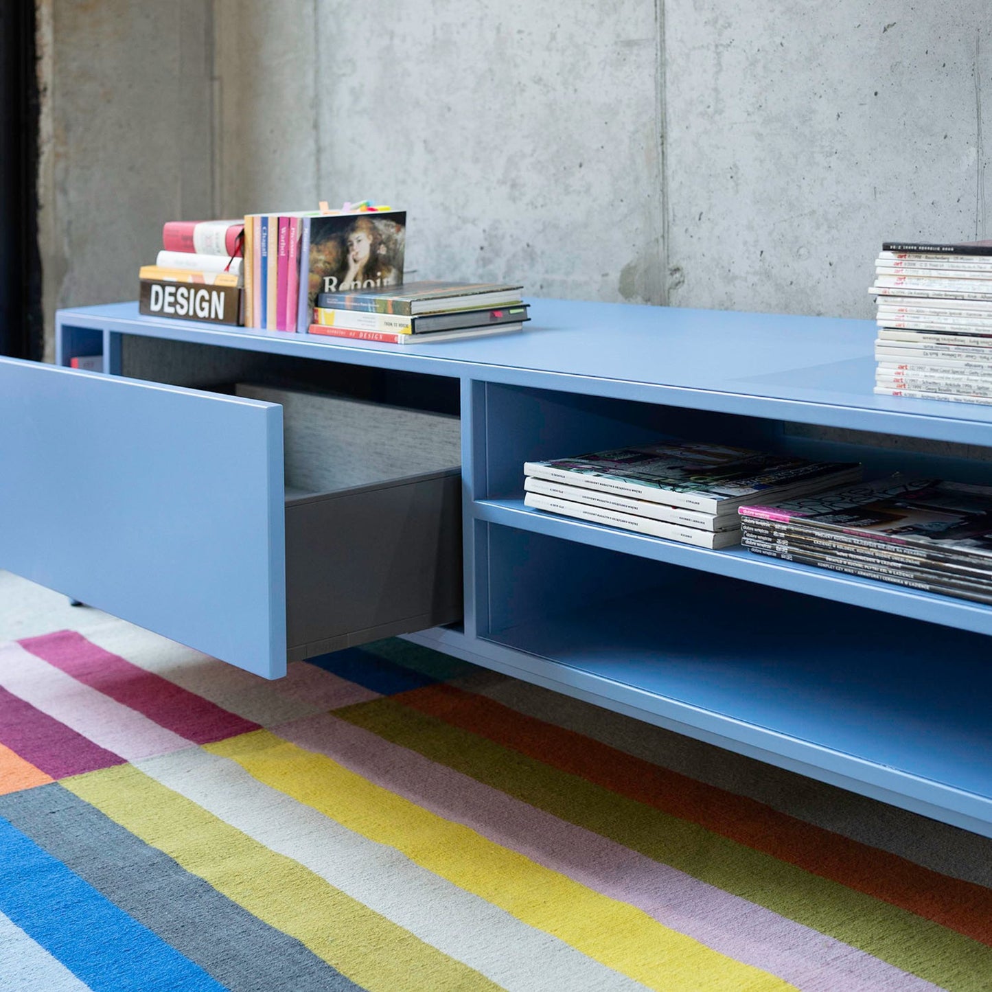 Shelf and drawer detail of the Sarine Lowboard in sky blue color, powder-coated steel, elegant and modern piece of furniture for your living room