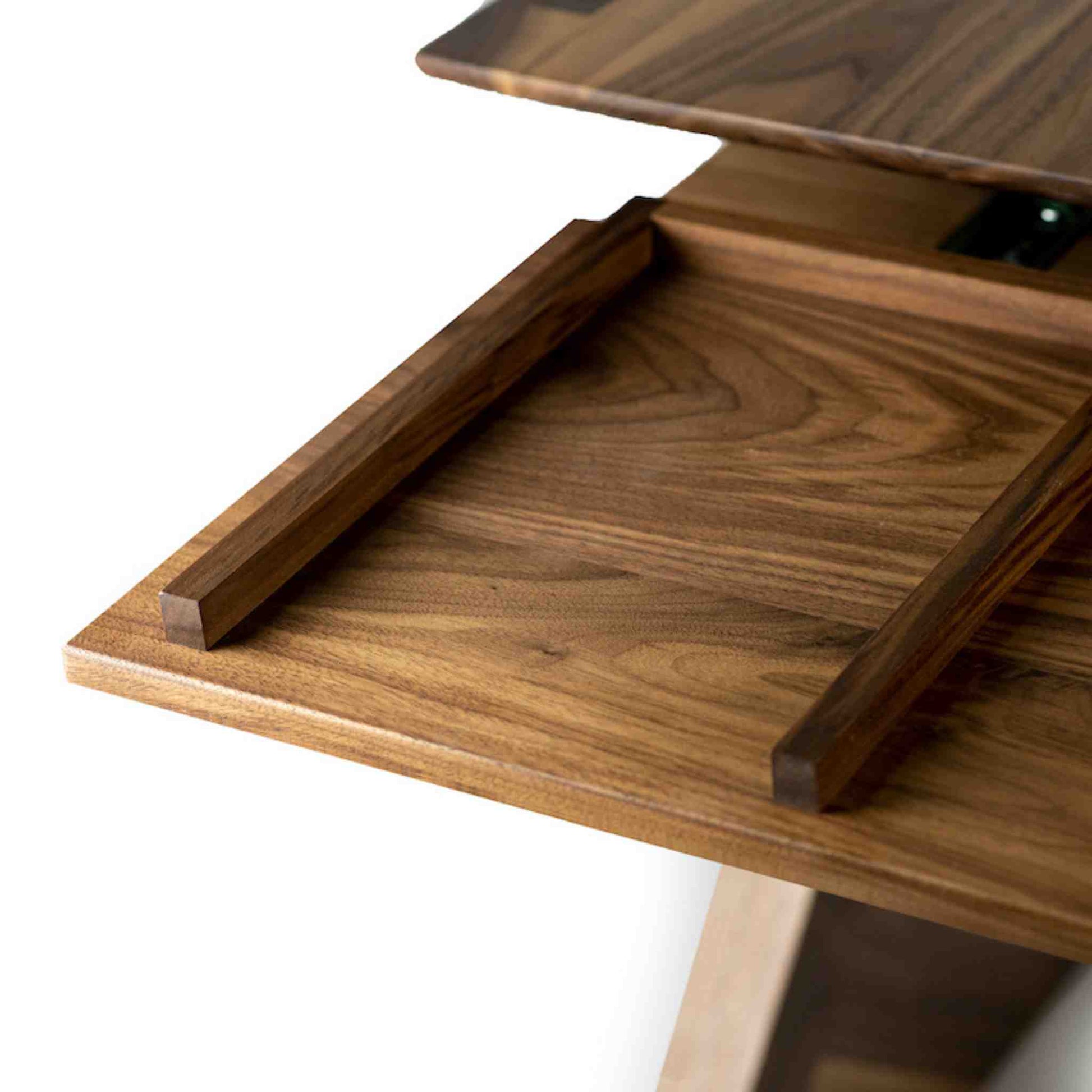 Tray detail of the Cervin desk with beautiful hourglass-shaped legs in solid walnut wood