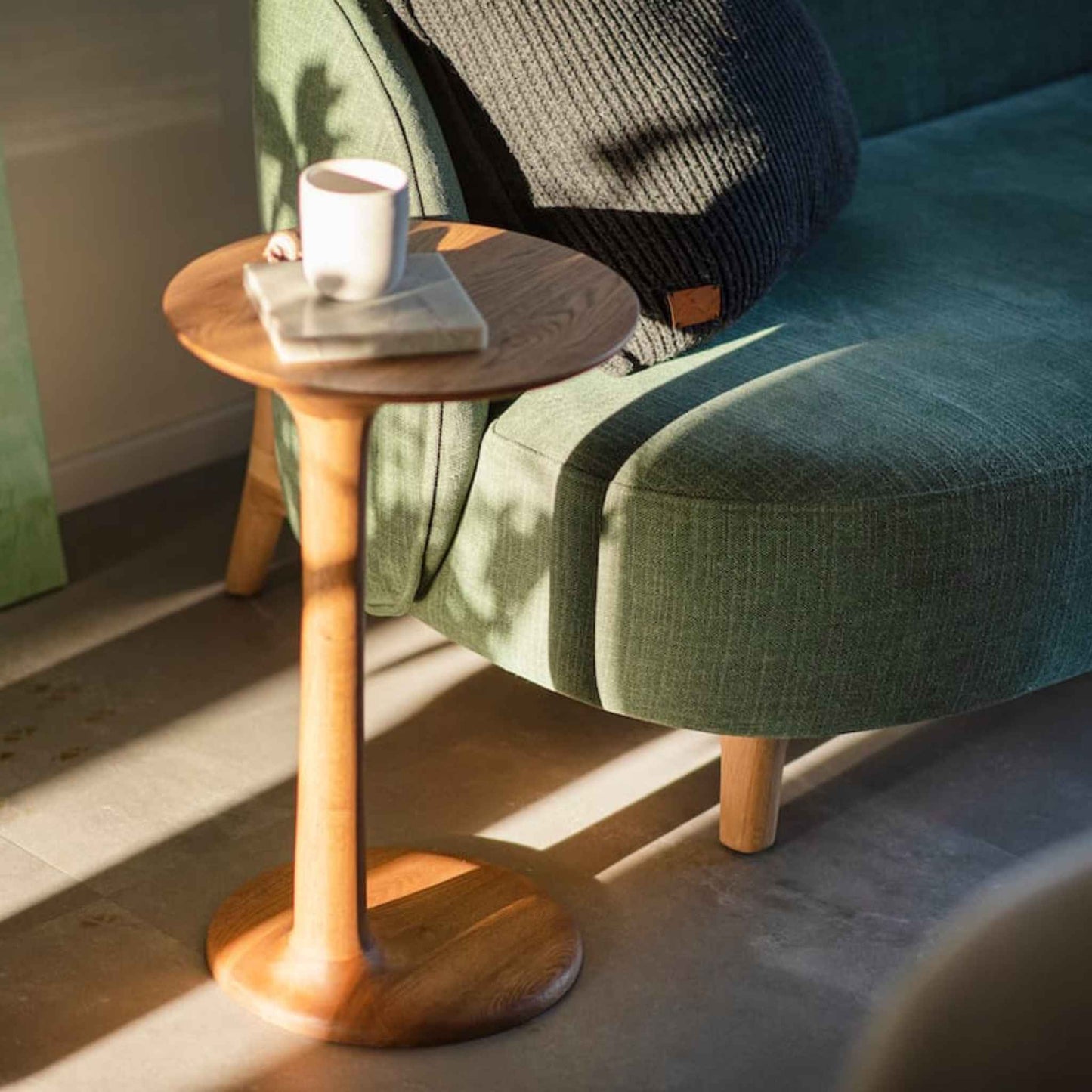 ÉTAUDORÉ Albula Side Table styled beside a sofa with a cup and book on top
