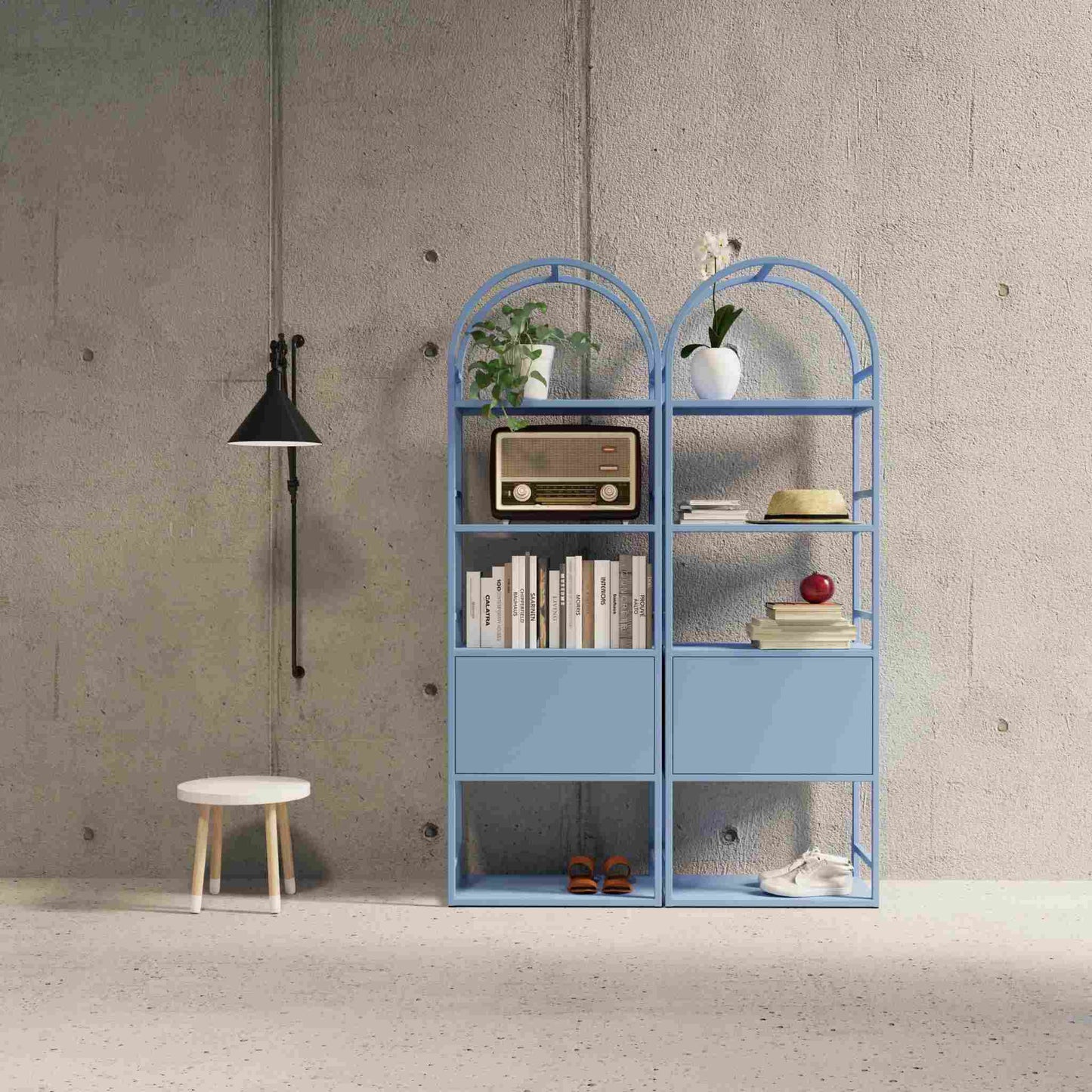 Interior arrangement with the arched bookcase Arkada, available in Switzerland through ÉTAUDORÉ, made from highest quality powdered coated steel in pastel sky blue color