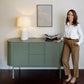 Anna, ÉTAUDORÉ founder, standing next to a Lumia sideboard in light olive