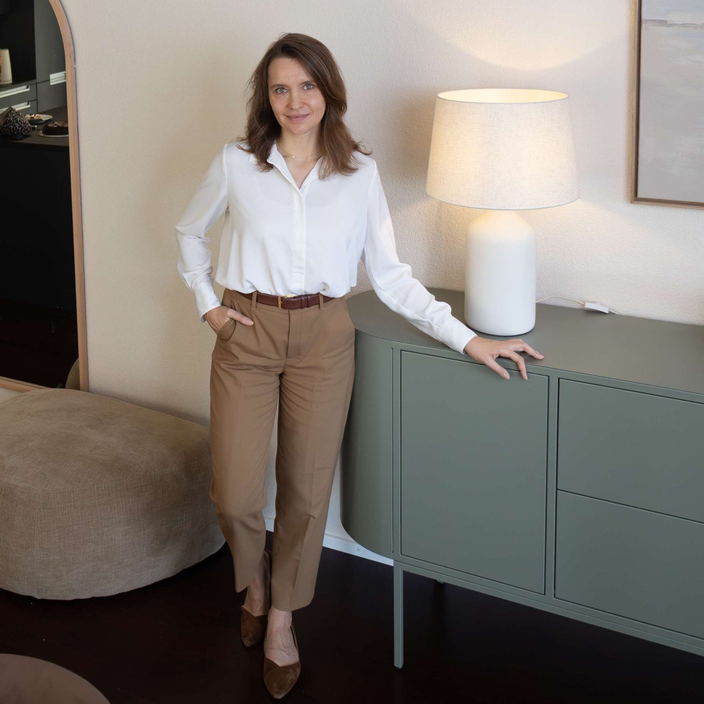 Anna, ÉTAUDORÉ founder, standing next to a Lumia sideboard in light olive