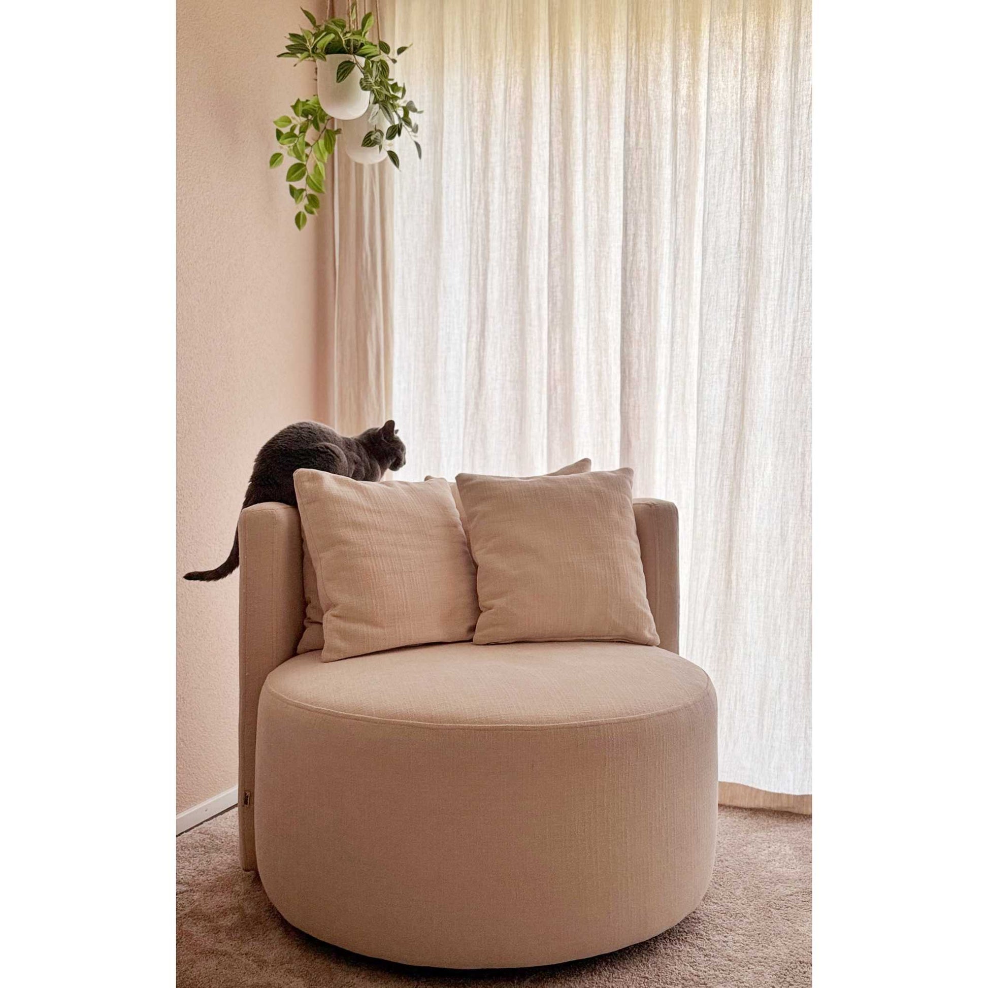 ÉTAUDORÉ Isola Armchair with swivel base – front view in MARE 02 fabric, styled in a modern interior setting