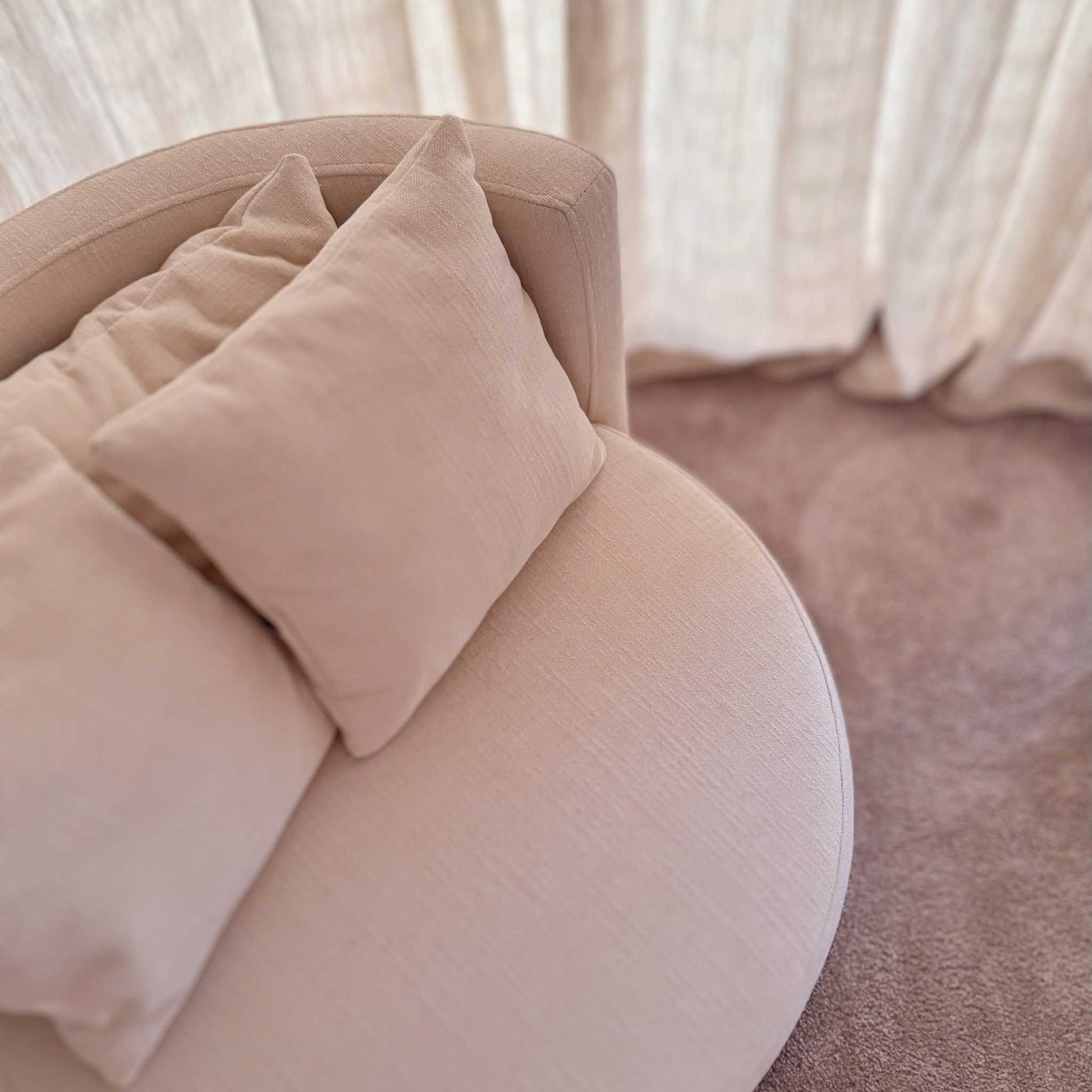 ÉTAUDORÉ Isola Armchair with swivel base – top view in MARE 02 fabric, styled in a modern interior setting