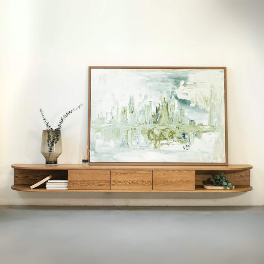 ÉTAUDORÉ San Salvatore wooden entertainment console with a framed abstract painting on a white wall