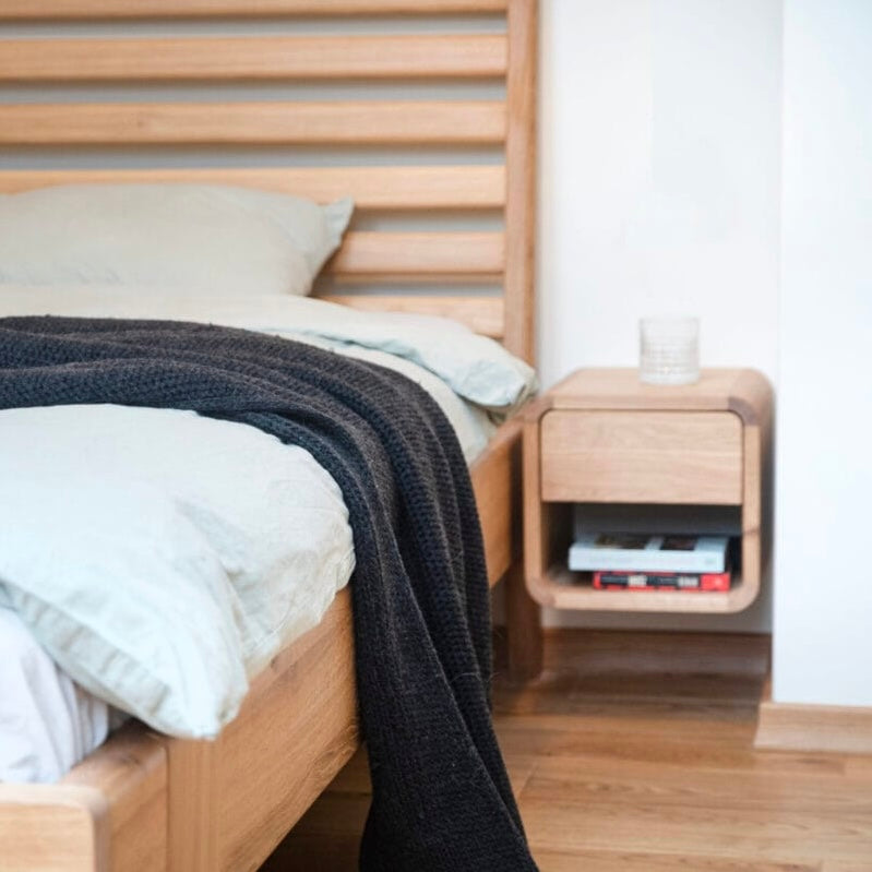 ETAUDORE Bernina wall-mounted bedside table in solid oak next to the Bernina bed
